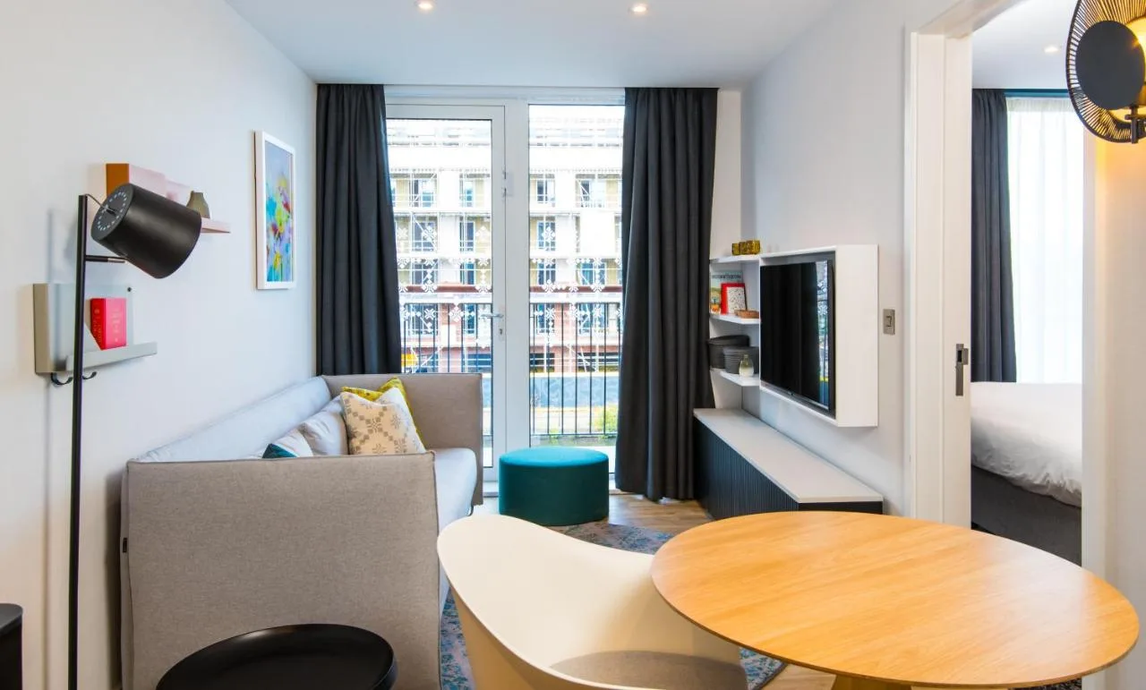 a living room with a couch and a table at Staybridge Suites - Cardiff by IHG in Cardiff