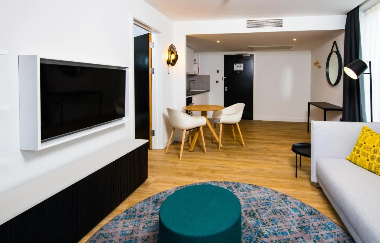 a living room with a couch and a tv at Staybridge Suites - Cardiff by IHG in Cardiff