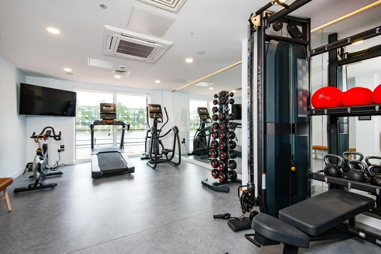 a gym with several treadmills and exercise machines at Staybridge Suites - Cardiff by IHG in Cardiff